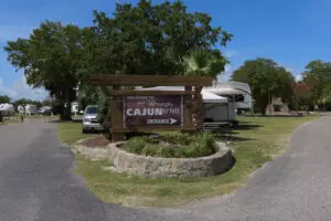 entrance to an RV park with a directional sign