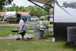 man cooking in front of an RV