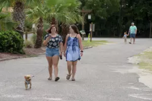 two women walking with a dog